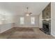 Spacious living room featuring a stone fireplace, carpeted floor, and lots of natural light at 1270 Della Way, Lawrenceville, GA 30043