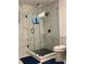 Modern bathroom featuring a glass shower enclosure, sleek black hardware, and pristine white tile work at 3533 Johns Rd, Tucker, GA 30084