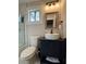 Modern bathroom featuring stylish vanity, toilet, and tub with a sliding glass door, all in pristine condition at 3533 Johns Rd, Tucker, GA 30084