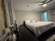Cozy bedroom with neutral tones, ceiling fan, modern art and comfortable queen bed at 3533 Johns Rd, Tucker, GA 30084