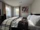 Inviting bedroom featuring a comfortable bed and two windows, providing natural light and pleasant views at 3533 Johns Rd, Tucker, GA 30084