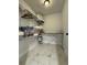 Well-organized closet featuring shelving, hanging space, marble-look floors and an ironing board at 3533 Johns Rd, Tucker, GA 30084