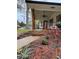 Inviting front porch with wooden columns and a ceiling fan, surrounded by fresh landscaping and a walkway at 3533 Johns Rd, Tucker, GA 30084