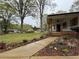 Home exterior featuring a covered porch, beautiful landscaping, and a walkway leading to the entrance at 3533 Johns Rd, Tucker, GA 30084