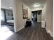 Hallway view into the bedroom and featuring modern art and gray plank floors at 3533 Johns Rd, Tucker, GA 30084