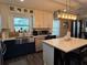 Stylish kitchen featuring white countertops, stainless steel appliances, dark lower cabinets, and a breakfast bar at 3533 Johns Rd, Tucker, GA 30084