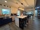 Open kitchen and living area with a large island, stainless steel appliances, and a view into the dining space at 3533 Johns Rd, Tucker, GA 30084
