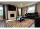 Comfortable living room featuring a brick fireplace, plush seating, and natural light from the large windows at 3533 Johns Rd, Tucker, GA 30084