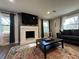 Cozy living room features a white fireplace, TV, modern furniture, and a colorful area rug at 3533 Johns Rd, Tucker, GA 30084