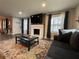 Stylish living room with painted fireplace, TV, dark sofa and colorful area rug at 3533 Johns Rd, Tucker, GA 30084