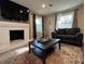 Comfortable living room with fireplace, TV, modern furniture and colorful area rug at 3533 Johns Rd, Tucker, GA 30084
