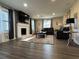Bright living room with a cozy fireplace, stylish furnishings, and hardwood floors at 3533 Johns Rd, Tucker, GA 30084