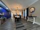Open-concept space with hardwood floors, a dining area, and a modern kitchen in the background at 3533 Johns Rd, Tucker, GA 30084