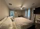 Spacious main bedroom with neutral tones, ceiling fan, TV and patterned curtains at 3533 Johns Rd, Tucker, GA 30084