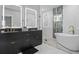 Modern bathroom with a freestanding tub, glass shower, and double vanity at 992 Beckwith Sw St, Atlanta, GA 30314