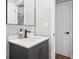 Contemporary bathroom with a dark vanity, quartz countertop, and modern fixtures at 992 Beckwith Sw St, Atlanta, GA 30314