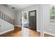 Welcoming entryway with hardwood floors, a staircase, and a door with decorative glass at 992 Beckwith Sw St, Atlanta, GA 30314