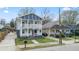 Attractive two-story home showcasing a dual porch, a long driveway, and proximity to neighboring houses at 992 Beckwith Sw St, Atlanta, GA 30314