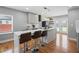 Modern kitchen featuring an island with seating, stainless steel appliances, and hardwood floors at 992 Beckwith Sw St, Atlanta, GA 30314