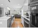 Modern kitchen with stainless steel appliances, a quartz countertop, and open to living room at 992 Beckwith Sw St, Atlanta, GA 30314