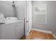 Functional laundry room with appliances, shelving, and natural light at 992 Beckwith Sw St, Atlanta, GA 30314