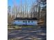Charming one-story home with a covered front porch surrounded by a treed front yard at 1610 Mulberry Rock Rd, Dallas, GA 30157