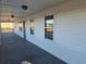Inviting covered porch with a gray wood floor, offering a relaxing outdoor space and natural light at 1610 Mulberry Rock Rd, Dallas, GA 30157
