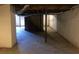The unfinished basement has painted walls, exposed beams, and stairs leading to the main floor at 1731 Dogwood Trl, Douglasville, GA 30134