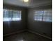 Comfortable bedroom featuring carpet, two windows, and neutral paint at 1731 Dogwood Trl, Douglasville, GA 30134