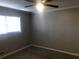 Neutral bedroom features gray carpet and a ceiling fan beneath standard-sized window at 1731 Dogwood Trl, Douglasville, GA 30134