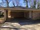 Attached brick carport featuring a concrete driveway and convenient access to the home at 1731 Dogwood Trl, Douglasville, GA 30134
