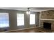 Bright living room featuring a brick fireplace, hardwood floors, and windows at 1731 Dogwood Trl, Douglasville, GA 30134