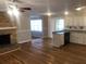 Spacious living room featuring hardwood floors, brick fireplace, and sliding glass doors at 1731 Dogwood Trl, Douglasville, GA 30134