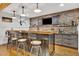 Basement bar area with a brick backsplash, custom shelving, and seating, perfect for entertaining guests at 7740 Nesbit Ferry Rd, Atlanta, GA 30350