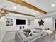 Finished basement area with large sofa, ottoman, built-in shelving, accent lighting, and decor at 7740 Nesbit Ferry Rd, Atlanta, GA 30350