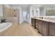 Spacious bathroom with a soaking tub, glass enclosed shower, and double vanity at 7740 Nesbit Ferry Rd, Atlanta, GA 30350