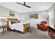 Warm bedroom featuring a comfortable bed, cozy reading chair, and ample natural light at 7740 Nesbit Ferry Rd, Atlanta, GA 30350