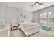 Cozy bedroom with white furniture, natural light, and a ceiling fan at 7740 Nesbit Ferry Rd, Atlanta, GA 30350