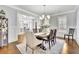Elegant dining room with hardwood floors, decorative chandelier, and plantation shutters for a classic look at 7740 Nesbit Ferry Rd, Atlanta, GA 30350