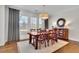 Dining room with large wood table, white rug, bright windows and Bon Appetit wall decor at 7740 Nesbit Ferry Rd, Atlanta, GA 30350