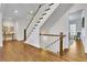 Inviting foyer featuring hardwood floors, elegant staircase with white railings, and bright, open space at 7740 Nesbit Ferry Rd, Atlanta, GA 30350