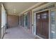 Inviting brick front porch with a dark wood door and gray shutters, offering a warm welcome at 7740 Nesbit Ferry Rd, Atlanta, GA 30350