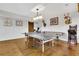 Game room features a ping pong table, shuffleboard, and hardwood floors, perfect for fun and games at 7740 Nesbit Ferry Rd, Atlanta, GA 30350
