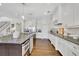 Bright kitchen features white cabinets, granite countertops, stainless steel appliances, and a large island at 7740 Nesbit Ferry Rd, Atlanta, GA 30350