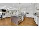 Gourmet kitchen featuring island, stainless steel appliances, and seamless integration with living spaces at 7740 Nesbit Ferry Rd, Atlanta, GA 30350