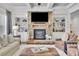 Cozy living room with a stone fireplace, built-in shelving, and comfortable seating arrangement at 7740 Nesbit Ferry Rd, Atlanta, GA 30350