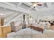 Spacious living room with coffered ceiling, stone fireplace, and seamless flow to kitchen and dining area at 7740 Nesbit Ferry Rd, Atlanta, GA 30350