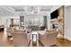 Bright living room featuring stone fireplace, large windows, hardwood floors, and elegant furniture arrangement at 7740 Nesbit Ferry Rd, Atlanta, GA 30350