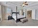 Primary bedroom featuring trey ceiling, sitting area and large bed and windows at 7740 Nesbit Ferry Rd, Atlanta, GA 30350