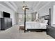 Spacious main bedroom with tray ceilings, a ceiling fan, and neutral decor at 7740 Nesbit Ferry Rd, Atlanta, GA 30350